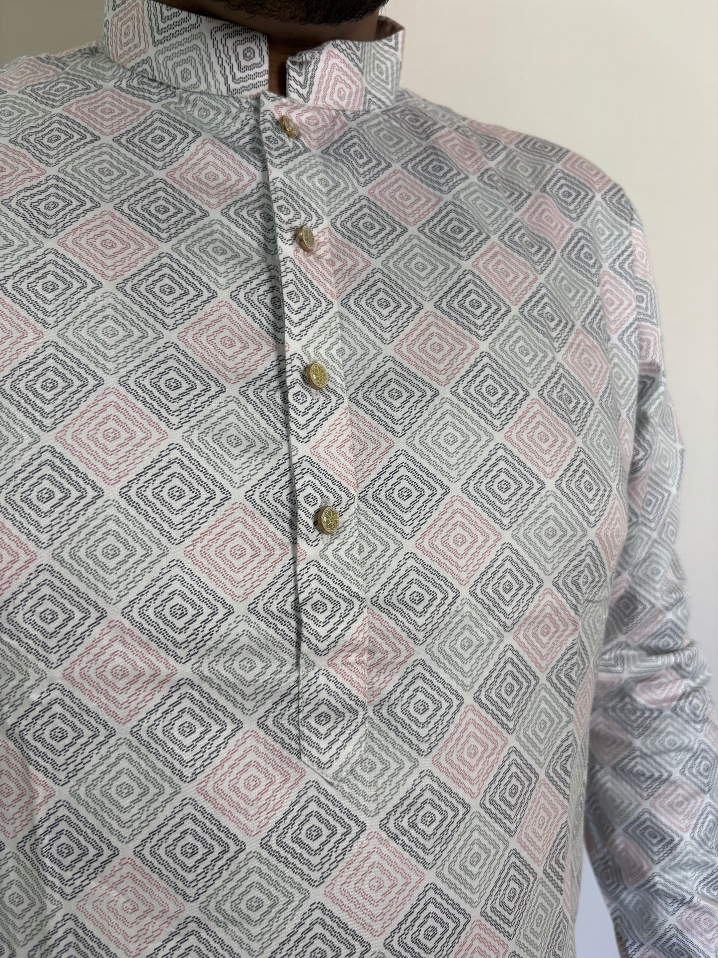 Close-up of golden buttons and geometric digital print on ivory Giza cotton kurta