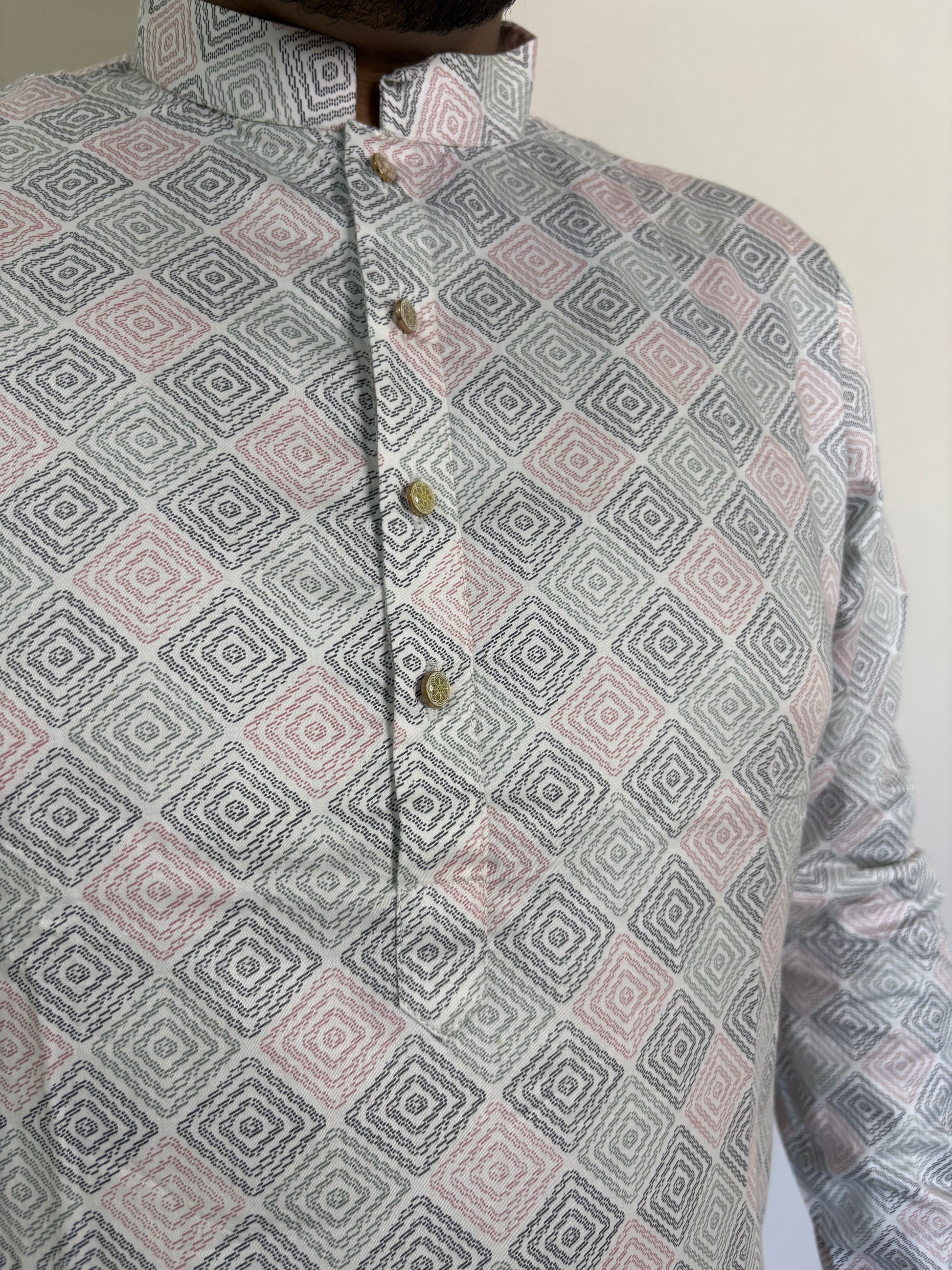 Close-up of golden buttons and geometric digital print on ivory Giza cotton kurta
