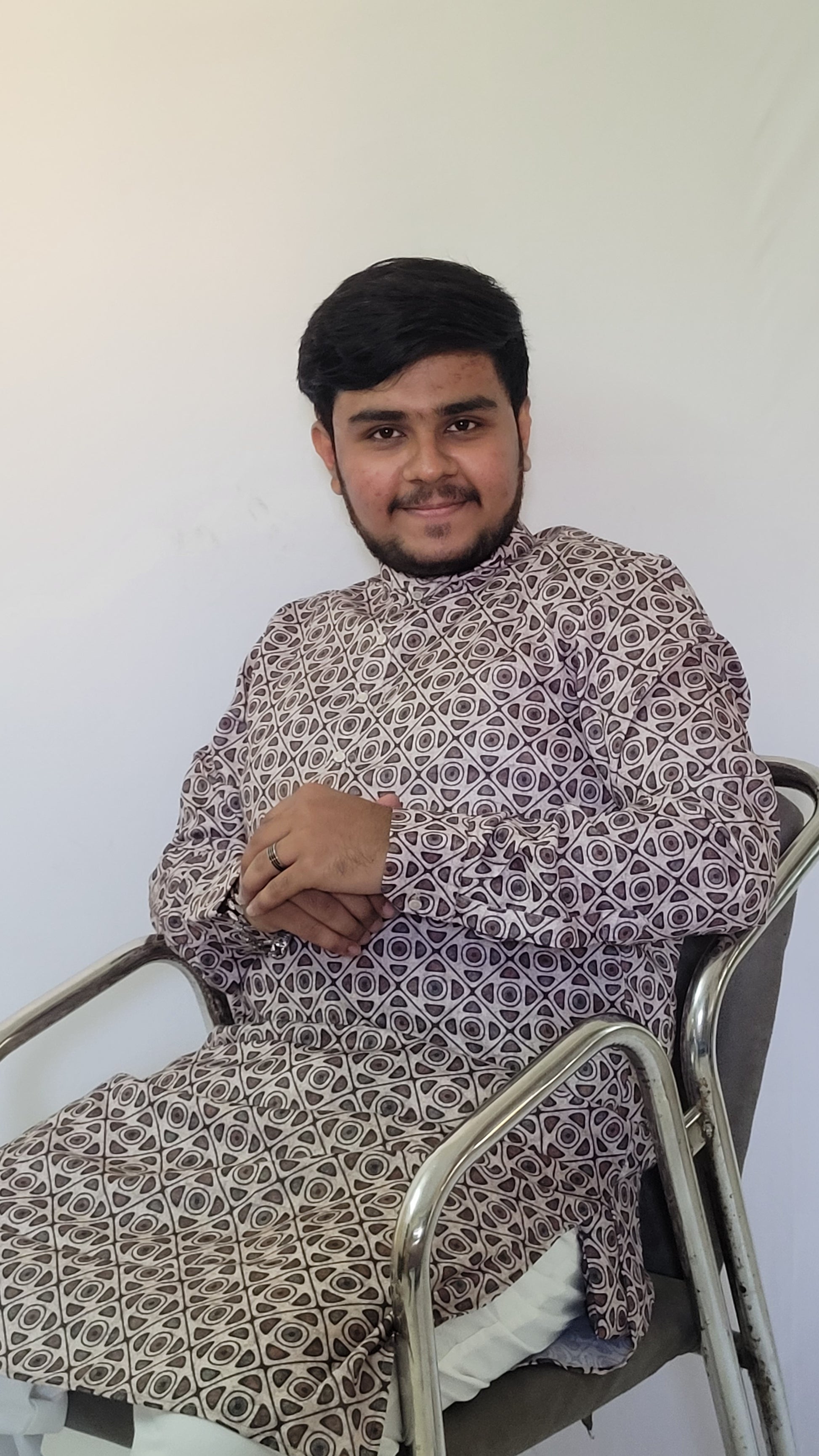 Seated right angle view of soft cotton kurta with geometric digital print – ethnic wear for brunch or pooja