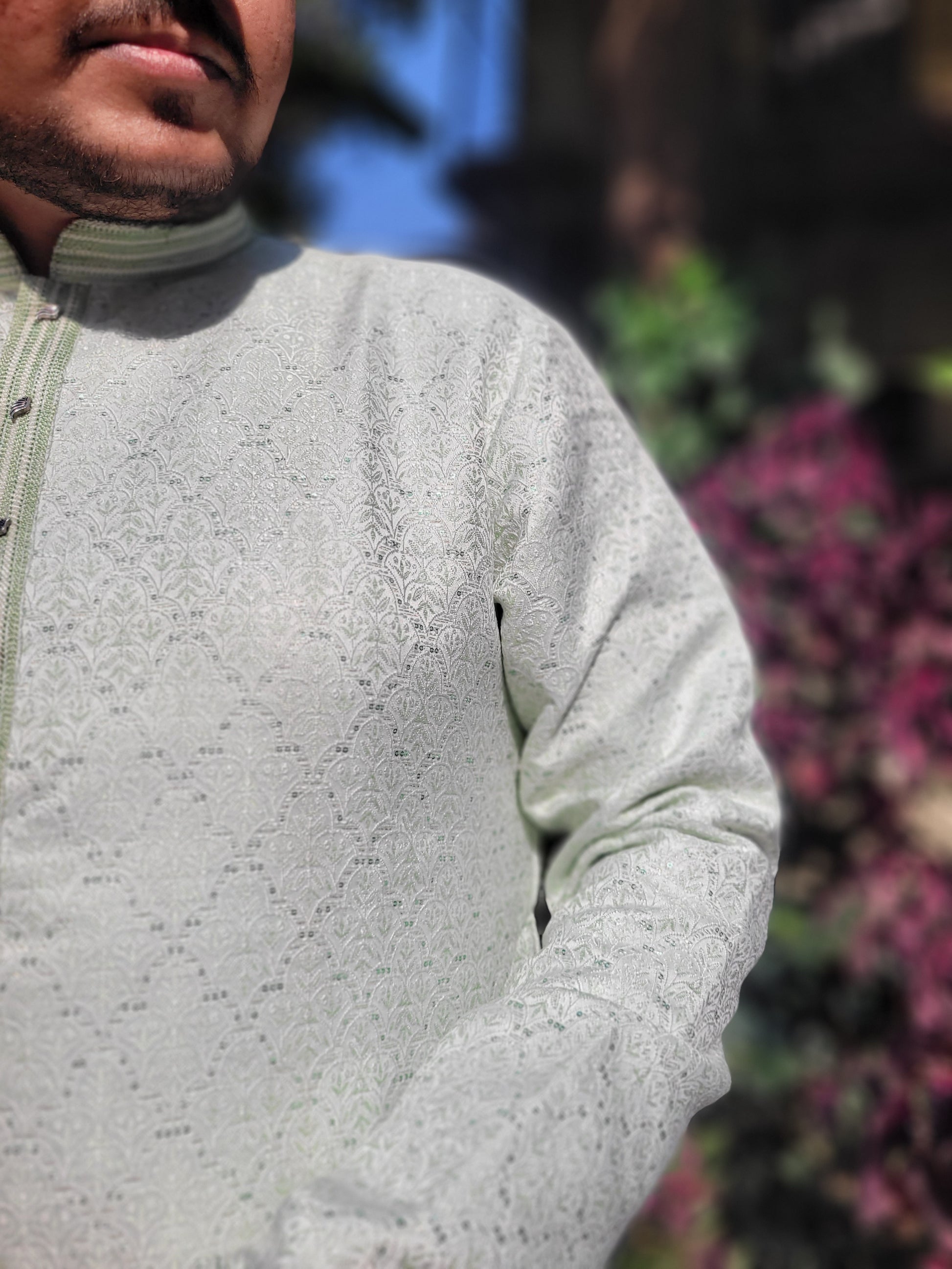 Close-up of embellished placket and self-woven jacquard texture on ivory mint kurta – premium festive detail