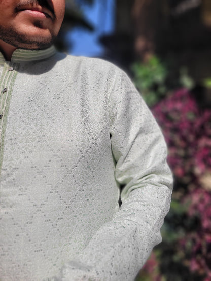 Close-up of embellished placket and self-woven jacquard texture on ivory mint kurta – premium festive detail