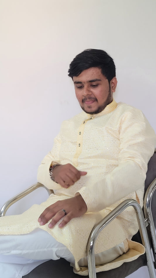 Seated front view of ivory jacquard kurta with sequin detailing – royal festive menswear
