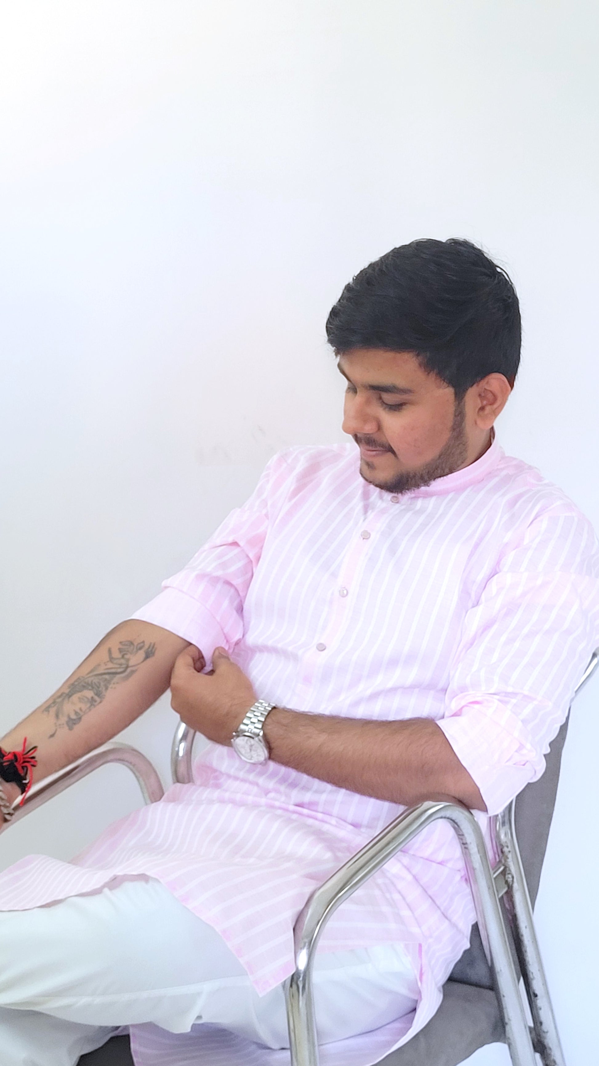 Angled right half-body profile of pastel pink kurta with white vertical stripes – modern ethnic kurta for men