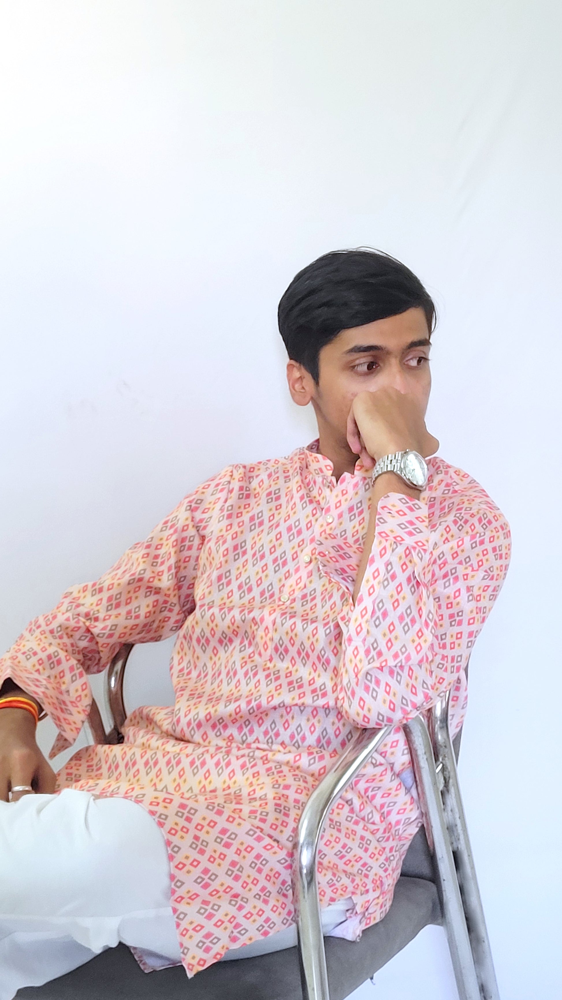 Seated side view of multicolor cotton kurta – traditional digital print with modern silhouette, model looking right