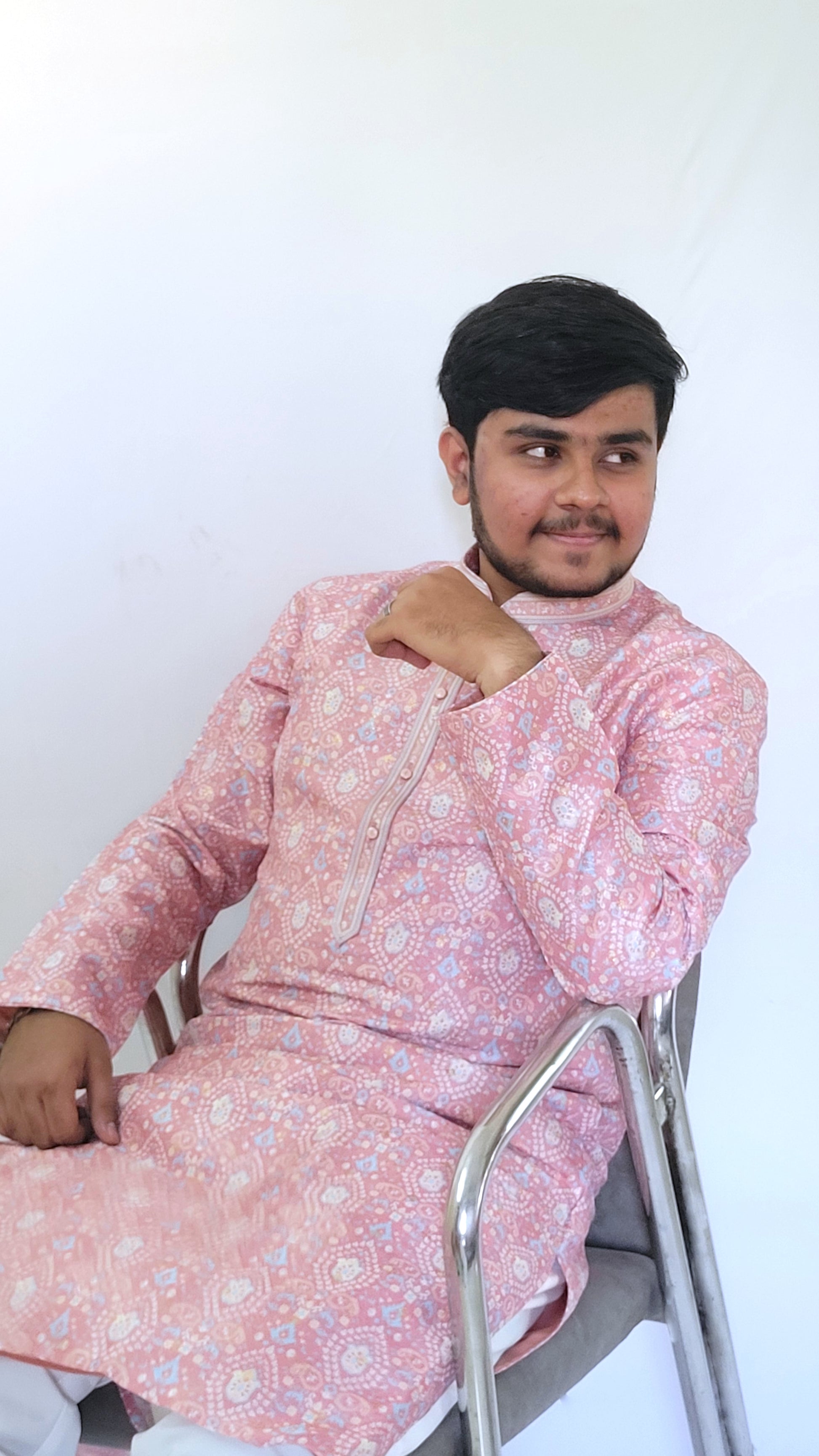 Seated right view of pastel pink digital print jacquard kurta – luxurious ethnic menswear for receptions or poojas